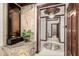 Elegant hallway with detailed ceiling trim, decorative stone features, and a clear view to other rooms at 11737 N 143Rd Dr, Surprise, AZ 85379