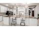 Well-lit kitchen boasts a large island, pendant lighting, and white cabinets for a bright, modern feel at 11737 N 143Rd Dr, Surprise, AZ 85379