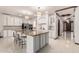 Spacious kitchen features granite countertops, white cabinets, and a large central island with seating at 11737 N 143Rd Dr, Surprise, AZ 85379