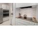 Close-up of a well-equipped kitchen with modern appliances, granite countertops, and stylish backsplash at 11737 N 143Rd Dr, Surprise, AZ 85379