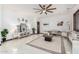 Inviting living room boasting tile floors, neutral furniture and natural lighting at 11737 N 143Rd Dr, Surprise, AZ 85379