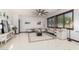 Bright living room with tile floors, neutral furniture, and a ceiling fan at 11737 N 143Rd Dr, Surprise, AZ 85379