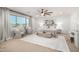 Serene main bedroom with neutral decor, ceiling fan, large windows, and sitting area at 11737 N 143Rd Dr, Surprise, AZ 85379