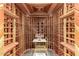 Custom wine cellar with beautiful wood racking, mood lighting, and space for displaying wine at 11737 N 143Rd Dr, Surprise, AZ 85379