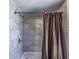 Modern bathroom with gray marble-look shower tiles and neutral brown shower curtain at 1191 E Avenida Fresca St, Casa Grande, AZ 85122