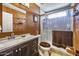 Well-lit bathroom with a glass shower enclosure, dark cabinetry, and interesting wall textures at 1191 E Avenida Fresca St, Casa Grande, AZ 85122