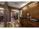Spacious bathroom with a double sink vanity, dark wood cabinets, and wall to wall mirror at 1191 E Avenida Fresca St, Casa Grande, AZ 85122