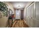 Inviting entryway featuring wood flooring, a decorative mirror, and a charming white door at 1191 E Avenida Fresca St, Casa Grande, AZ 85122