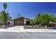 Inviting single-story home with a well-maintained lawn, mature trees, and a gated driveway at 1191 E Avenida Fresca St, Casa Grande, AZ 85122