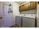 Laundry room with washer, dryer and overhead cabinets at 1191 E Avenida Fresca St, Casa Grande, AZ 85122