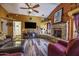 Spacious living room with a stone fireplace, TV, and comfortable seating at 1191 E Avenida Fresca St, Casa Grande, AZ 85122