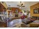 Comfortable living room featuring a stone fireplace, wood floors, and comfortable seating at 1191 E Avenida Fresca St, Casa Grande, AZ 85122