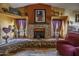 Cozy living room featuring a brick fireplace and decorative shelves at 1191 E Avenida Fresca St, Casa Grande, AZ 85122