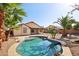 Private backyard features a sparkling pool, desert landscaping, and a covered patio, perfect for relaxation at 12217 W Edgemont Ave, Avondale, AZ 85392