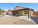 Wonderful covered patio with a fan overlooking the backyard and brick-paved sections of landscaping at 12217 W Edgemont Ave, Avondale, AZ 85392