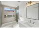 Stylish bathroom showcasing modern fixtures, sleek tiling, and a bathtub with a shower at 12217 W Edgemont Ave, Avondale, AZ 85392