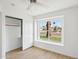Bedroom featuring a ceiling fan and a window with a view of the neighborhood and an open closet at 12217 W Edgemont Ave, Avondale, AZ 85392