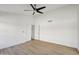Spacious bedroom features modern ceiling fan, wood-look floors, and a closet for ample storage at 12217 W Edgemont Ave, Avondale, AZ 85392