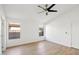This is a lovely room with natural light, wood-look floors, and a ceiling fan for optimal comfort at 12217 W Edgemont Ave, Avondale, AZ 85392