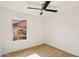 Minimal bedroom with a ceiling fan and a view of the backyard and neighboring houses at 12217 W Edgemont Ave, Avondale, AZ 85392