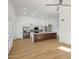 Contemporary kitchen featuring a large center island with a stone countertop and stainless steel appliances at 12217 W Edgemont Ave, Avondale, AZ 85392