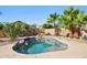 Relaxing backyard pool with a rock feature and lush landscaping to provide a private oasis at 12217 W Edgemont Ave, Avondale, AZ 85392