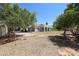 Large backyard with mature trees and patio area at 12721 W Georgia Ave, Litchfield Park, AZ 85340