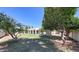 Large backyard with grass and mature trees, offering a private outdoor space at 12721 W Georgia Ave, Litchfield Park, AZ 85340