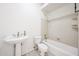 Bathroom with white pedestal sink, toilet, and bathtub/shower combo at 12721 W Georgia Ave, Litchfield Park, AZ 85340