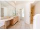 Bright bathroom offers a single sink vanity, walk in shower with grab bars and a window at 12721 W Georgia Ave, Litchfield Park, AZ 85340