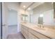 Bathroom featuring dual sinks and large mirror at 12721 W Georgia Ave, Litchfield Park, AZ 85340