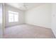 Bright bedroom features a large window and neutral carpet at 12721 W Georgia Ave, Litchfield Park, AZ 85340