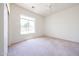 Bright bedroom features a large window and neutral carpet at 12721 W Georgia Ave, Litchfield Park, AZ 85340