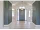 Inviting foyer with neutral tile flooring, decorative columns, and a stylish front door with sidelights at 12721 W Georgia Ave, Litchfield Park, AZ 85340