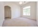Bright living room featuring plush carpeting, arched windows, and plenty of natural light at 12721 W Georgia Ave, Litchfield Park, AZ 85340