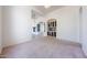 Bright living room featuring plush carpeting, arched windows, and plenty of natural light at 12721 W Georgia Ave, Litchfield Park, AZ 85340