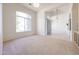 Bright living room featuring plush carpeting, arched windows, and plenty of natural light at 12721 W Georgia Ave, Litchfield Park, AZ 85340