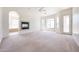 Spacious living room with fireplace, large windows, and access to the backyard offers natural light at 12721 W Georgia Ave, Litchfield Park, AZ 85340