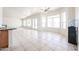 Expansive living room featuring tile floor, French doors, and an open layout to the kitchen at 12721 W Georgia Ave, Litchfield Park, AZ 85340