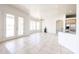 Expansive living room featuring tile floor, French doors, and an open layout to the kitchen at 12721 W Georgia Ave, Litchfield Park, AZ 85340
