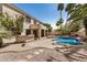 Inviting backyard featuring a swimming pool, covered patio and built in grill at 13599 W Monte Vista Rd, Goodyear, AZ 85395