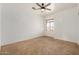 Bedroom with plush carpeting, ceiling fan, neutral paint and a window at 13599 W Monte Vista Rd, Goodyear, AZ 85395