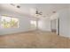 Bedroom featuring plush carpet, ceiling fan, large window with blinds, and neutral paint at 13599 W Monte Vista Rd, Goodyear, AZ 85395