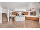 Bright kitchen featuring a breakfast bar, custom cabinets, and stainless steel appliances at 13599 W Monte Vista Rd, Goodyear, AZ 85395