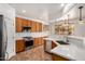 Well-lit kitchen features updated white countertops, stainless steel appliances, and beautiful light fixtures at 13599 W Monte Vista Rd, Goodyear, AZ 85395