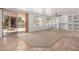 Bright open-concept living room featuring a sliding door and built-in shelving at 13599 W Monte Vista Rd, Goodyear, AZ 85395