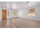 Bright open-concept living room with neutral tones, carpet, and tile flooring at 13599 W Monte Vista Rd, Goodyear, AZ 85395