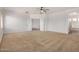 Spacious main bedroom with plush carpet, ceiling fan, and ensuite bathroom and walk-in closet at 13599 W Monte Vista Rd, Goodyear, AZ 85395