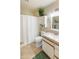 Cozy bathroom featuring classic tile work, a new vanity, and a shower with a patterned curtain at 13807 N Garden Court Dr, Sun City, AZ 85351