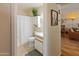 Bright bathroom featuring white fixtures, neutral tile, and a decorative plant adding a touch of nature at 13807 N Garden Court Dr, Sun City, AZ 85351